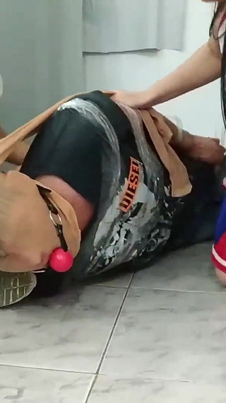 Football Player Pantyhosed and Hogtied on the Floor by Two Cheerleaders!