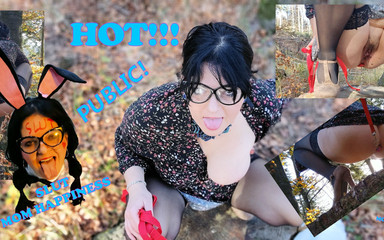 Buttplug in her ass with a leash pissing on a tree stump in the forest