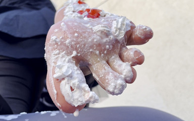 Strawberries with whipped cream on my bare feet