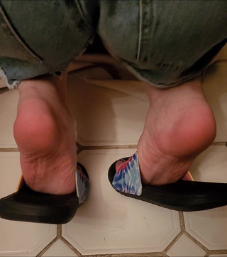 Soles of My Feet in Flip Flops While Getting the Tub Ready