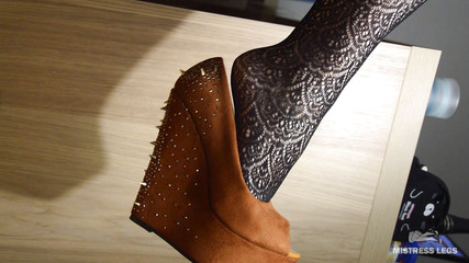 My lazy dangling shoe on the feet in black fishnets