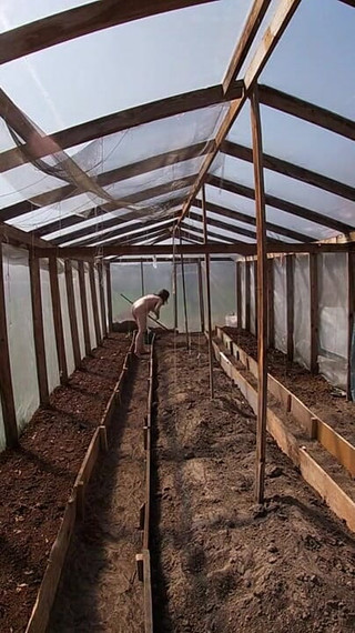Nude house wife working in the greenhouse
