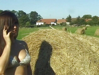 Sexy brunette with big boobs in erotic outdoors scene