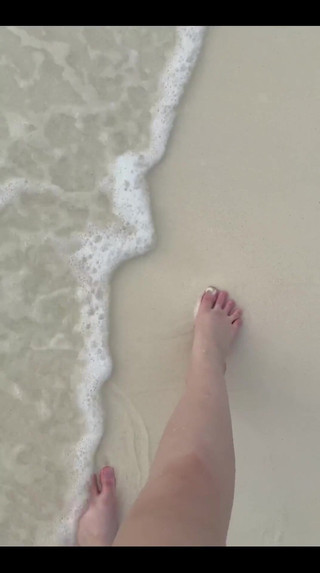 Running My Bare Feet on the White Beach Sand by the Ocean