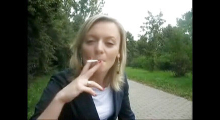 Blonde beauty smoking a cigarette outdoors