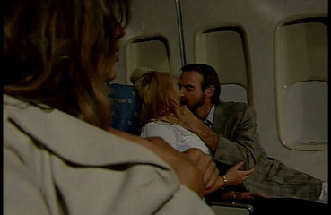 Busty hot stewardess gets licked and fucked by the captain while her busty cowerker masturbating